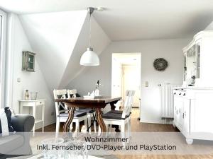 a kitchen and dining room with a table and chairs at Moderne Ferienwohnung in Strandnähe - Urlaubsträume am Meer in Neue Tiefe Fehmarn +35 photos