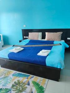 a bed with blue sheets and towels on it at Bedroom301 Kata Beach Phuket in Kata Beach