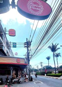 a group of signs on the side of a street at Bedroom301 Kata Beach Phuket in Kata Beach
