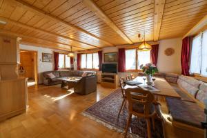 a living room with a couch and a table at Sonnegge in Wildhaus