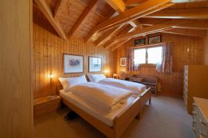a bedroom with a bed in a wooden room at Sonnegge in Wildhaus