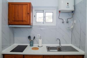 a kitchen counter with a sink and a window at Mountain View Star in Estreito da Calheta +63 photos