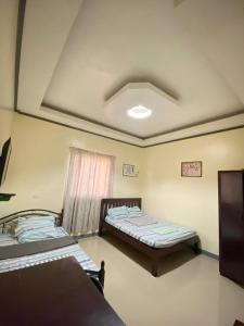 a room with two beds and a window at BICAMM Inn in Sampong