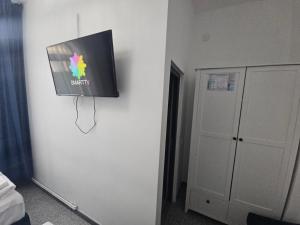 a flat screen tv hanging on a wall at Perfect Ploiesti in Ploieşti +22 photos