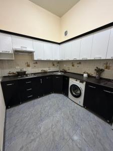 a kitchen with a washer and a washing machine at Al-Adl Guest House in Bukhara +13 photos