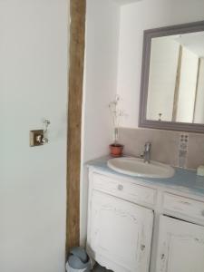 a bathroom with a sink and a mirror at Ti Forn - Les fours à pain in Dinéault +29 photos