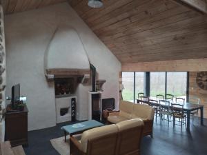 a living room with a couch and a table at Ti Forn - Les fours à pain in Dinéault