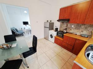a kitchen with a table and a dining room at City house in Myrina