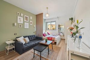 a living room with a couch and a table at Sweett - Maison Blanche in Juan-les-Pins