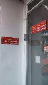 a red sign on the side of a building at Bedroom401 Kata Beach Phuket in Kata Beach
