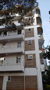a tall building with windows and balconies on it at Amani Home in Kisii