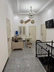 a living room with a couch and a table at Al-Adl Guest House in Bukhara