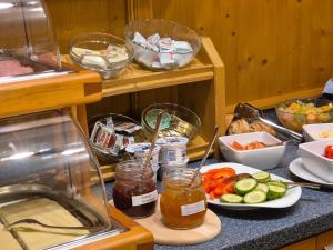 a kitchen counter with vegetables and jars of food at Pension Aberger - Joker Card inclusive in Saalbach-Hinterglemm
