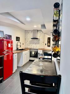 a kitchen with a red refrigerator and a table with a wine glass at Maxine Manor in Douglasville