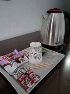 a counter with food and chopsticks and a coffee maker at Leopard edirne in Edirne