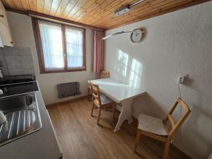 a kitchen with a table and chairs in a room at Adli in Disentis +8 photos