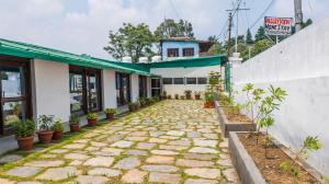 a stone walkway in front of a building at The Valley View Homestay in Lansdowne