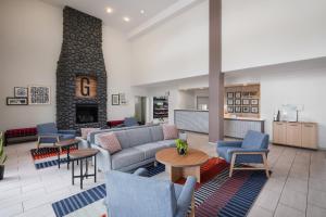 a lobby with a couch and chairs and a fireplace at Garner Hotel Liberty Lake by IHG in Liberty Lake