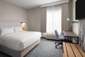 a hotel room with a bed and a desk at Garner Hotel Liberty Lake by IHG in Liberty Lake +30 photos