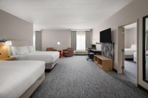a hotel room with two beds and a desk at Garner Hotel Liberty Lake by IHG in Liberty Lake