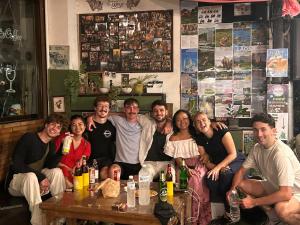 a group of people posing for a picture in a bar at The Cabin Backpackers Hostel & Bar in Chiang Mai