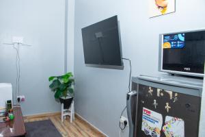 a living room with a tv on top of a dresser at Patrach Homes in Wote