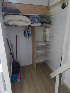 a walk in closet with shelves and a wooden table at La maisonnette des Fontilles in Mauriac