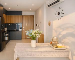 a vase of flowers on a table in a kitchen at SHome, căn hộ 55m2,2 phòng ngủ, Oceanpark 1 in Gia Lâm Pho
