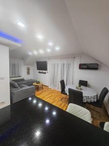 a living room with a couch and a table at Apartman Antonela in Sop