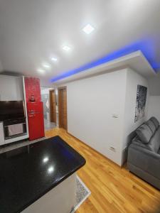 a living room with a red refrigerator and a couch at Apartman Antonela in Sop
