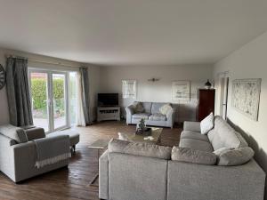 a living room with two couches and a table at The Cherries in Penrhyn Bay