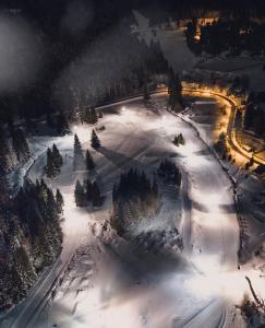 an aerial view of a ski slope in the snow at night at Chata Hella in Pernink