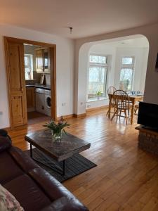 a living room with a couch and a table at Ashmore Mews in Galway