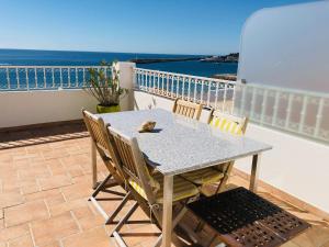 a table and chairs on a balcony with the ocean at Casa Eugenia in Sesimbra