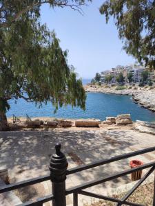a fence next to a body of water at By the wave luxurious studios in Piraeus