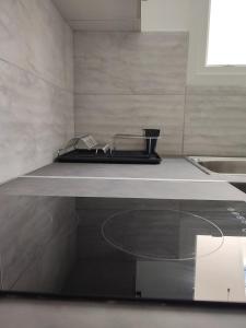 a kitchen with a counter top and a sink at By the wave luxurious studios in Piraeus +43 photos