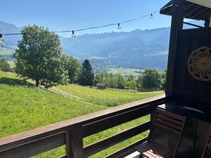 a bench on a porch with a view of a field at Il Nido - Family Apartment con Spa & Mini Club a Cavalese in Carano