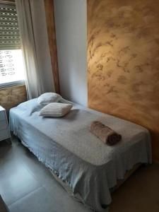 a bedroom with a bed with two towels on it at Sea views-Balcony-Sleeps 6-Parking-AirCon Heating in Daimuz