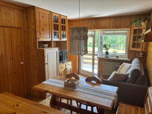 a living room with a couch and a table at Il Nido - Family Apartment con Spa & Mini Club a Cavalese in Carano
