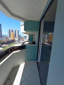 a balcony of a building with a view of a city at Duplex 11 Pessoas-Churrasqueira-Próximo ao Mar in Itapema