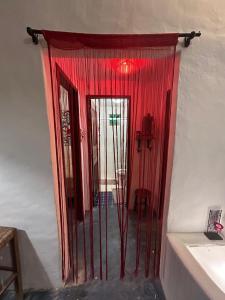 a door with red curtains in a room at Casa Bosque Guajiru in Trairi +20 photos