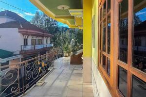 a balcony of a house with a view of the mountains at Bromo Indah Lestari Homestay Mitra RedDoorz in Pasuruan