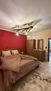 a bedroom with a large bed with a ceiling fan at Kerkini's Harmony House in Kerkini
