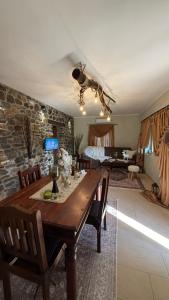 a living room with a wooden table and a bedroom at Kerkini's Harmony House in Kerkini +39 photos
