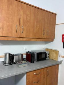 a kitchen counter top with a microwave and appliances on it at Casa da Avó Virgínia in Elvas