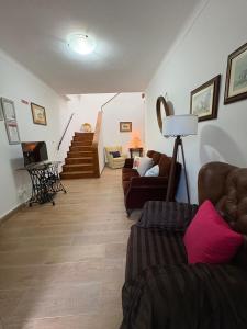 a living room with two couches and a staircase at Casa da Avó Virgínia in Elvas