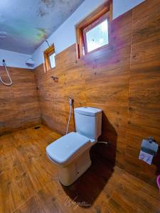 a bathroom with a toilet in a wooden wall at Elephant paradise Safari resort in Udawalawe +41 photos