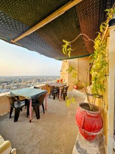 a patio with a table and chairs on top of a building at Hotel Mirage in Jaisalmer