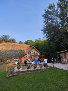 a group of people standing in front of a house at Forest Cottage 2024 in Lábatlan