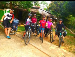 a group of people riding bikes on a dirt road at Elephant paradise Safari resort in Udawalawe